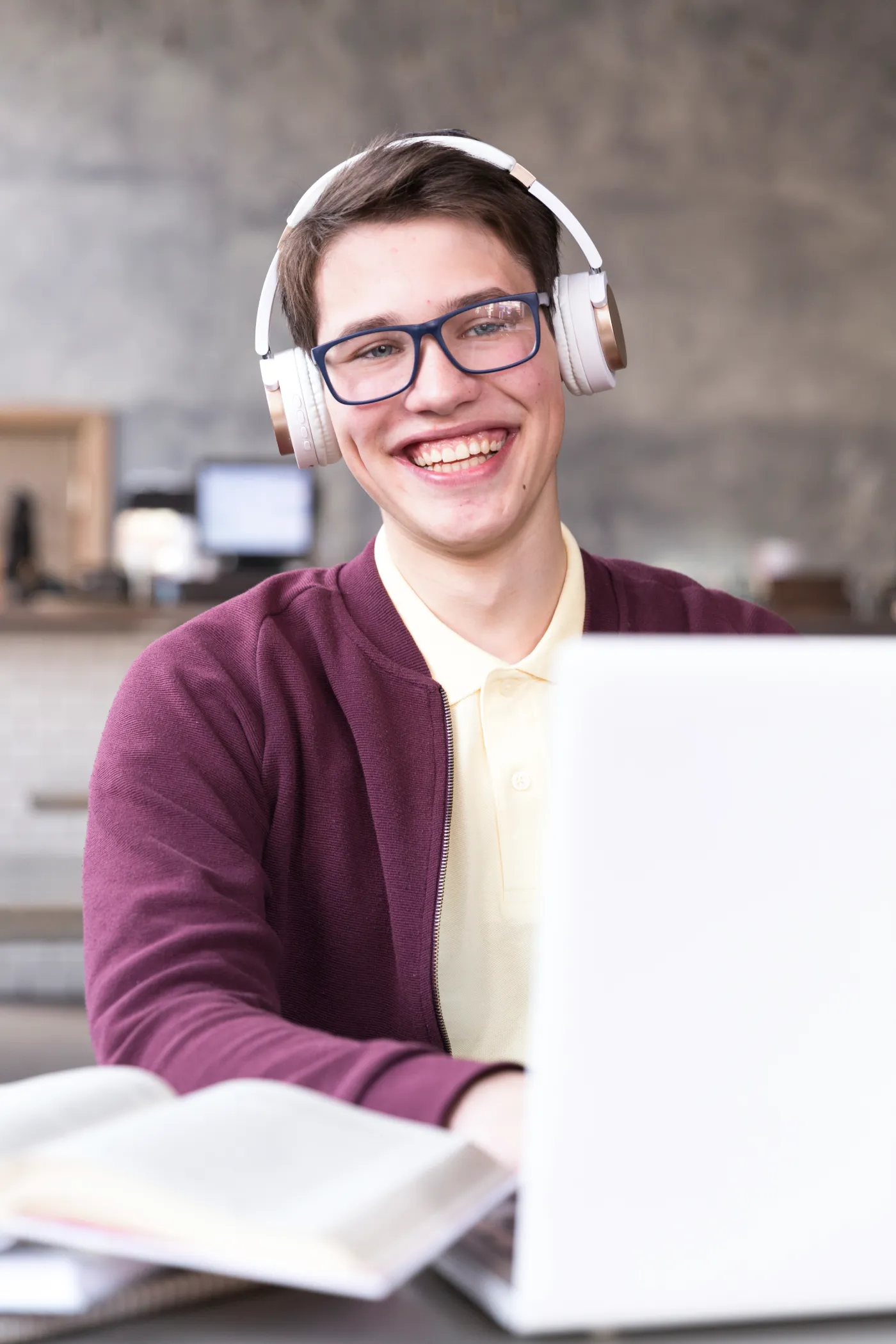 Uśmiechnięty uczeń szkoły średniej uczy się matematyki online w słuchawkach